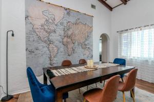 a dining room with a map of the world on a wall at Relax with Family at the Beach! in St. Pete Beach