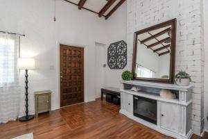 a living room with a mirror and a fireplace at Relax with Family at the Beach! in St. Pete Beach