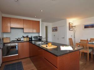 a kitchen with wooden cabinets and a counter top at 1 bed in Westward Ho 61767 in Westward Ho