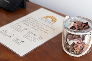 a glass jar filled with food next to a paper at Vila Girassol in Aracaju