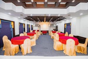a room with rows of tables and chairs with reditures at Garden Hotel Panvel in Navi Mumbai