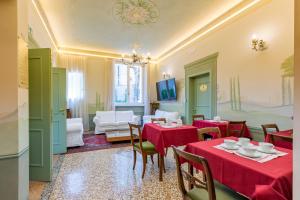 a dining room with red tables and chairs at Villa Tortorelli in Florence