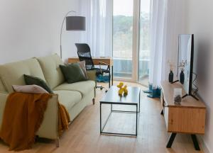 a living room with a couch and a table at Cozy Home in Bečići