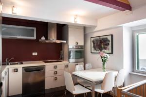 a kitchen and dining room with a table and chairs at Duplex with terrace in the city centar in Split