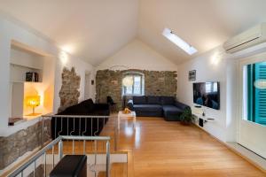 a living room with a stone wall at Duplex with terrace in the city centar in Split