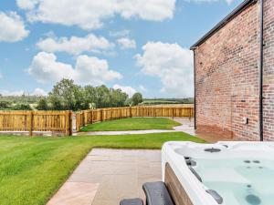 a bath tub in a yard with a fence at 3 Bed in Wintersett 93234 