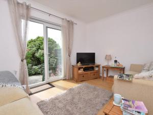 a living room with a couch and a large window at 2 Bed in Bude 53635 in Bude