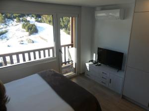 TV a/nebo společenská místnost v ubytování Ideal per una escapada