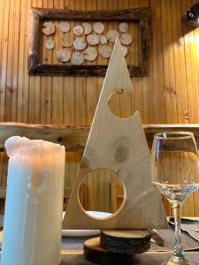 a wooden table with a candle and a glass of wine at Guest House Rila in Govedartsi