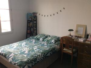 a bedroom with a bed and a desk next to a desk sidx sidx at Villa St. Georges in La Rochelle