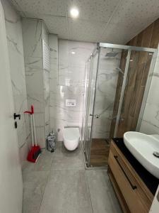 a bathroom with a shower and a toilet and a sink at A flat with two rooms close the Lara Beaches d12 in Altınkum
