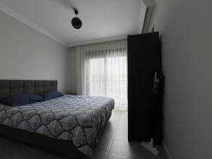 a bedroom with a bed and a window at A flat with two rooms close the Lara Beaches d12 in Altınkum
