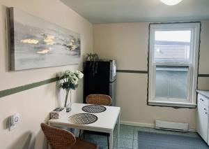 a small kitchen with a table and a refrigerator at Comfortable Apt #4 with Office Space in Halifax
