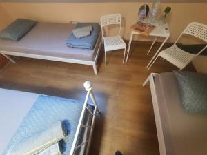 a room with a bed and a table and chairs at Kapana Stay at Center Plovdiv in Plovdiv