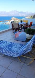 a blue bed sitting on top of a balcony at Mirabello Sea House in Agios Nikolaos