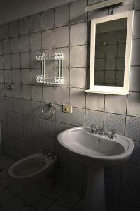 a bathroom with a sink and a mirror and a toilet at Agriturismo Trigna in Lamezia Terme