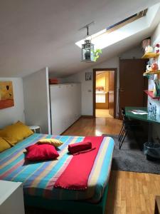 a bedroom with a large bed and a desk at Monolocale A Modo Mio B&B in Bologna
