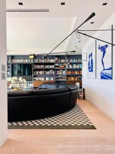 a living room with a black couch and bookshelves at V Penthouse in Vieste