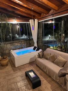 a living room with a couch and a tub at Green Oasis Gabella in Castelforte