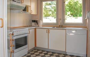 a kitchen with white cabinets and a window at Awesome Home In Hejls With 4 Bedrooms, Sauna And Wifi in Hejls