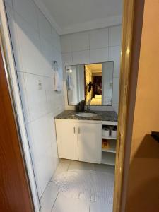 a small bathroom with a sink and a mirror at TV Conego Leitão 2709 ap 203 in Castanhal