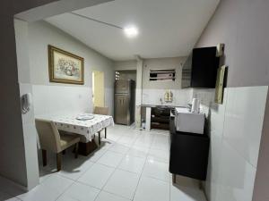a kitchen with a table and a kitchen with a refrigerator at TV Conego Leitão 2709 ap 203 in Castanhal +21 photos