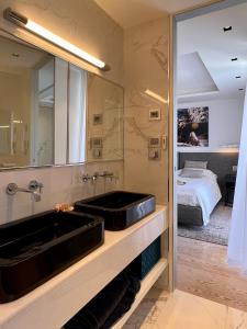 a bathroom with a sink and a large mirror at V Penthouse in Vieste