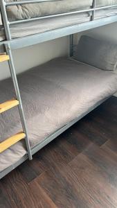 a bunk bed in a room with a wooden floor at Sarsfield Hostel in Dublin