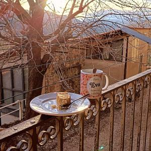 a piece of cake on a plate next to a coffee mug at Allotjaments rurals Can Punti in Vallfogona de Ripolles