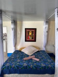 a bedroom with a bed with two slippers on it at Exclusive Beach & Calm at Vaiora House in Fitii