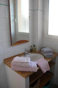 a bathroom with a sink and a mirror and towels at Picouveau in Cassis