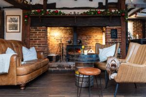a living room with a couch and a fireplace at The Bull on the Green in Newick