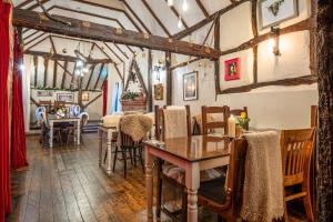 a dining room with a table and some chairs at The Bull on the Green in Newick