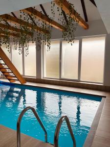 an indoor swimming pool with windows and a large swimming pool at Holiday Home Aladin's in Bihać