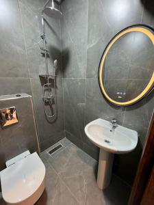 a bathroom with a sink and a toilet and a mirror at Appartement à 10 min de la mer à pied in Casablanca