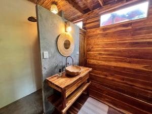 a bathroom with a sink and a wooden wall at Casa Dos Almas in Santa Marta
