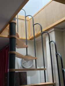 a staircase in a room with wooden shelves at studio indépendant 800 m de la gare du Mans in Le Mans