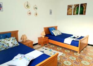 a bedroom with two beds and two night stands at The Marsa story in La Marsa