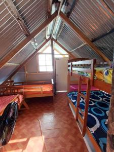 a room with two bunk beds in a attic at Cabaña La Punta in Colón