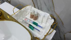 a table with toothbrushes and toothpaste on it at Хостел, Гостиничные номера, Гостиничный дом, Гостевой дом in Shymkent