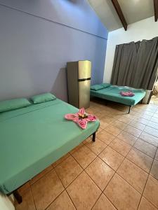 a room with two beds in a room at Wide Mouth Frog Conchal in Brasilito