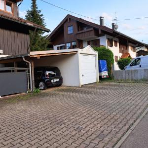 a car parked in a garage next to a house at Hirsch Glück in Ofterschwang