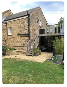 a brick house with a staircase leading to a yard at The Oaks A private room in our home With its own entrance with internal doors locked More suited to quieter guests wanting a peaceful stay in Consett