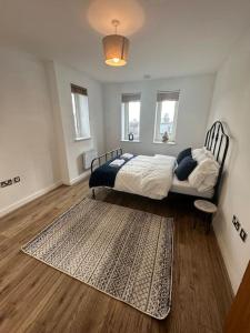 a bedroom with a bed and a rug on the floor at Stratford Apartment - walk to ABBA Voyage in London