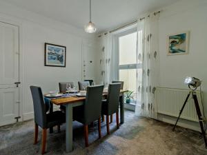 a dining room with a table and chairs and a camera at 4 Bed in Brixham 90449 in Brixham