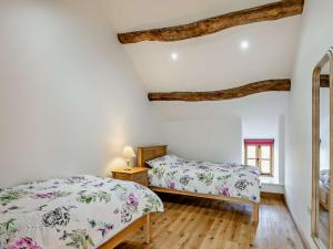 a bedroom with two beds and a window at 3 Bed in Bala 91365 in Bala