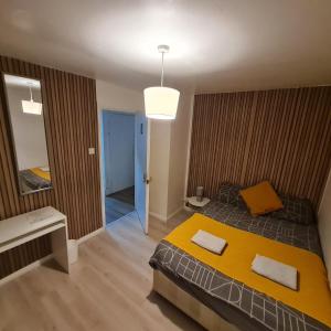 a bedroom with a large bed and a mirror at London E2 Rooms in London