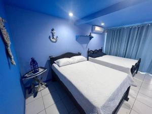 A bed or beds in a room at Puntarenas, Apartamento M&M