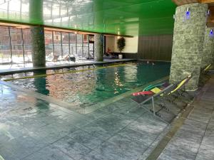 a large swimming pool with chairs in a building at Appartement Lanslebourg-Mont-Cenis, 3 pièces, 6 personnes - FR-1-508-300 in Lanslebourg-Mont-Cenis