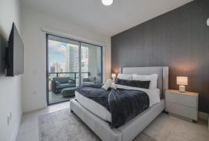 a bedroom with a large bed and a large window at Prime location: Luxury Condo at brickell in Miami